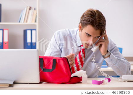 Man with first aid kit in the office Man with first aid kit in the office 46390560