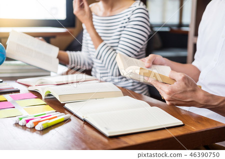 Young students classmates help friend catching up workbook and l Young students classmates help friend catching up workbook and l 46390750