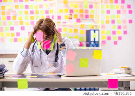 Male doctor with many conflicting prioritites Male doctor with many conflicting prioritites 46391195