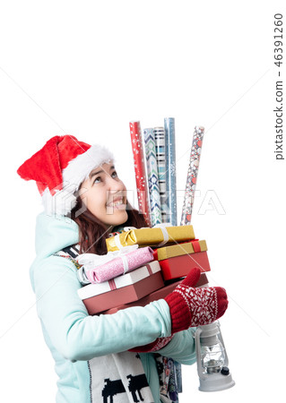 Photo of woman in Santa's cap with boxes with gifts with wrapping paper Photo of woman in Santa's cap with boxes with gifts with wrapping paper 46391260