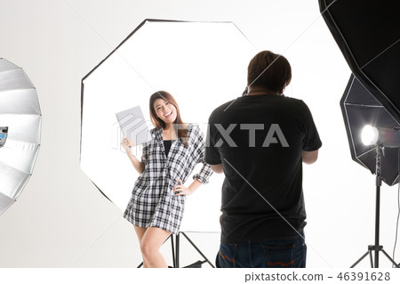 Photographer and model working in studio. 46391628