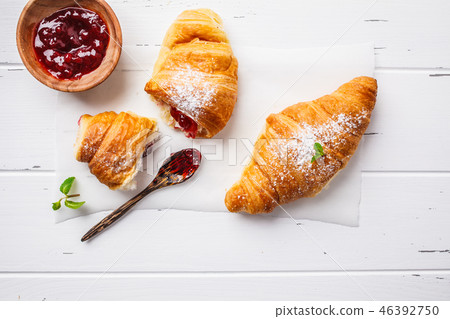 Croissants with berry jam on white background. Croissants with berry jam on white background. 46392750