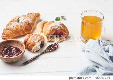 Croissants with berry jam on white background. Croissants with berry jam on white background. 46392751