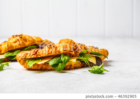 Croissants with cheese and salad on white  46392905