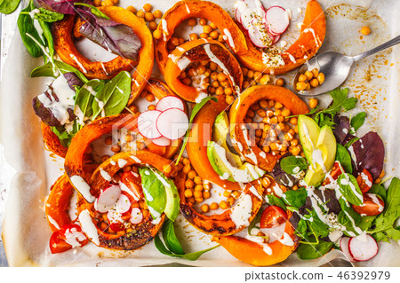 Baked pumpkin with chickpeas on a baking sheet Baked pumpkin with chickpeas on a baking sheet 46392979