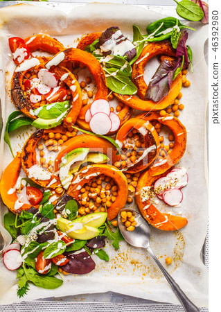 Baked pumpkin with chickpeas on a baking sheet Baked pumpkin with chickpeas on a baking sheet 46392980