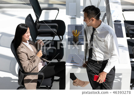 Two Asian businessmen, man and woman taking with happiness in mo Two Asian businessmen, man and woman taking with happiness in mo 46393278
