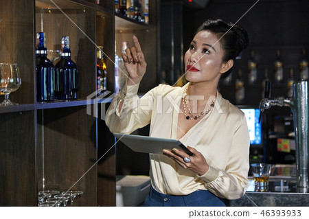 Checking shelves in bar Checking shelves in bar 46393933