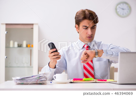 Young attractive businessman working in the office Young attractive businessman working in the office 46394069