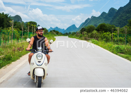 Traveler riding motorbike on Asian trip Traveler riding motorbike on Asian trip 46394082