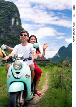 Couple having fun on motorbike around rice fields in China Couple having fun on motorbike around rice fields in China 46394083