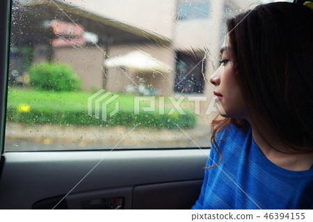 Pensive woman in car Pensive woman in car 46394155