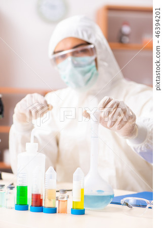 Young biochemist wearing protective suit working in the lab 46394201