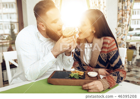 Happy man and woman having lunch in a restaurant Happy man and woman having lunch in a restaurant 46395208