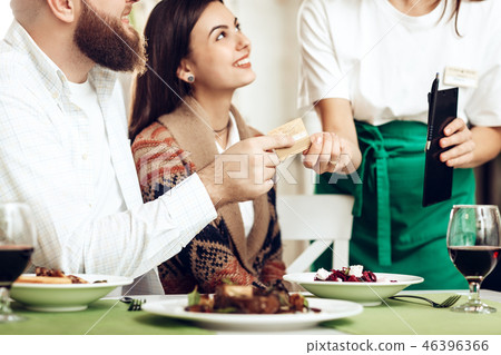 The waitress brought the couple a bill for dinner The waitress brought the couple a bill for dinner 46396366