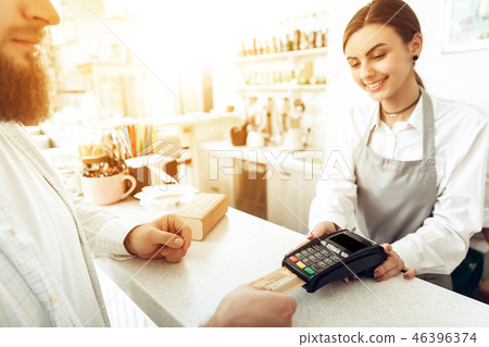 Cheerful cashier using digital device for payment 46396374