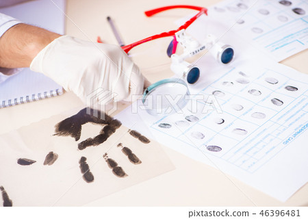 Forensic expert studying fingerprints in the lab Forensic expert studying fingerprints in the lab 46396481
