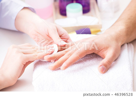 Hands during manicure care session Hands during manicure care session 46396528