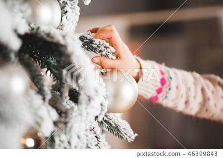 Happy girl decorating a beautiful Christmas tree 46399843