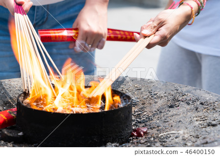 Lighting candle pray to Buddha at Longhua temple Lighting candle pray to Buddha at Longhua temple 46400150