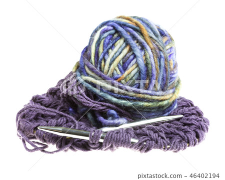 ball of yarn and needles in knitted cloth isolated 46402194