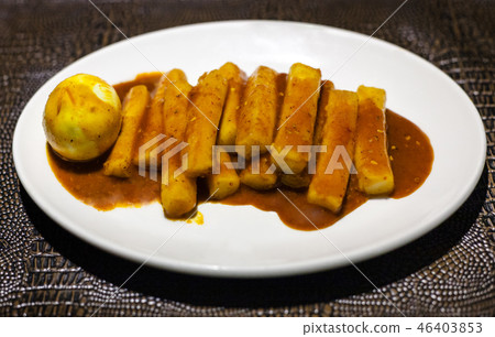 Tteok bokki snack on white plate on leather board 46403853
