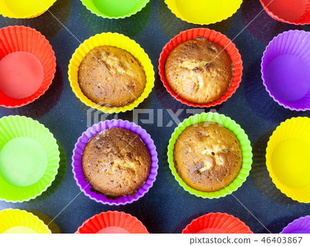 top view of four cupcakes in multicolored molds top view of four cupcakes in multicolored molds 46403867