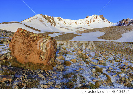 A large boulder in defocus on the way to the top A large boulder in defocus on the way to the top 46404265