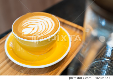 Latte art coffee cup in yellow glass 46404837
