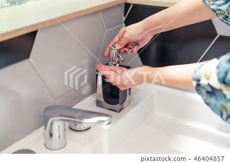 women washing hand with liquid soap in restroom women washing hand with liquid soap in restroom 46404857