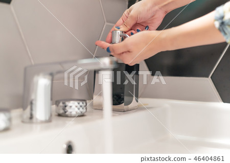 women washing hand with liquid soap in restroom women washing hand with liquid soap in restroom 46404861