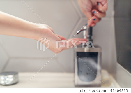 women washing hand with liquid soap in restroom women washing hand with liquid soap in restroom 46404863
