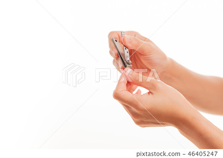 woman hand cutting nails using nail clipper 46405247