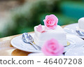 White cupcakes decorated with pink flowers. 46407208