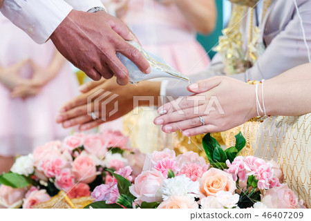 Thai wedding,Close up of hands pouring water. Thai wedding,Close up of hands pouring water. 46407209