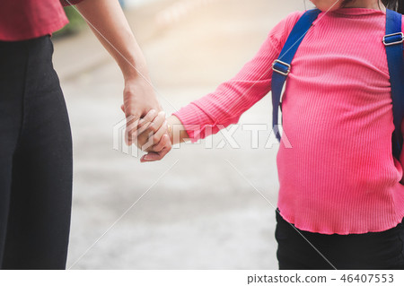 Mother holding hand  daughter with backpack  Mother holding hand  daughter with backpack  46407553