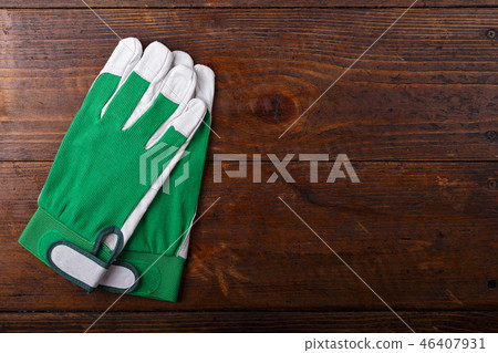 Construction gloves on a wooden background 46407931