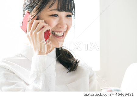 A woman talking on a smartphone A woman talking on a smartphone 46409451