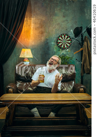The crazy football fan watching soccer game on television The crazy football fan watching soccer game on television 46410619