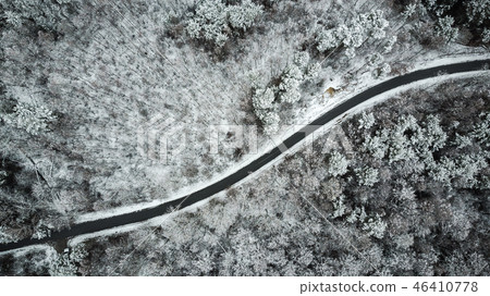 Aerial view of snow covered road in winter forest 46410778