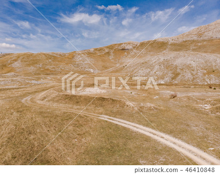Dirt road in remote Bosnia steppe 46410848