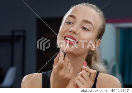 Stylist keeping lipstick and doing makeup. Stylist keeping lipstick and doing makeup. 46411847