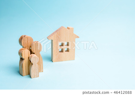 family stands near a wooden house family stands near a wooden house 46412088