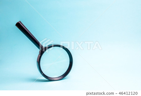 Magnifying glass on blue background.  46412120