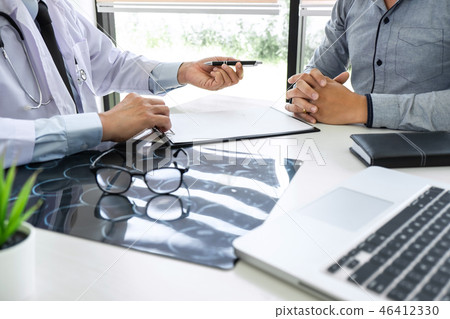 Professor Doctor recommend treatment method with patient and hol 46412330