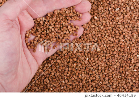 A handful of buckwheat over a background of buckwheat A handful of buckwheat over a background of buckwheat 46414189
