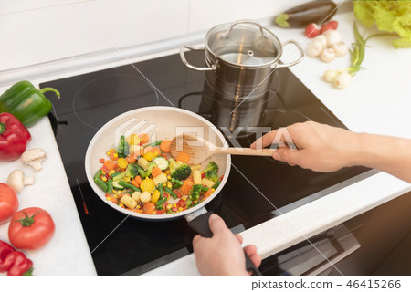 Fresh vegetables fried in a pan Fresh vegetables fried in a pan 46415266