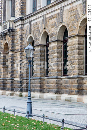 Metal vintage street pole lamp near old building  46415445