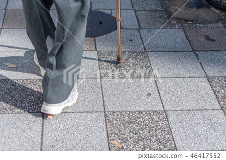 Elderly people walking with a cane 46417552