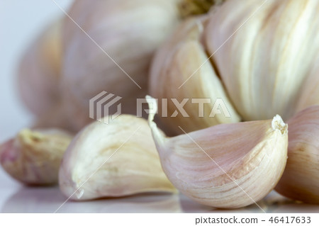 Closeup garlic on white background. Closeup garlic on white background. 46417633